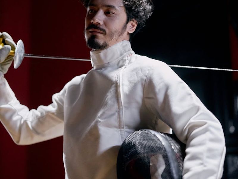 Man holding a difficult bodyweight pose showing strength and control.